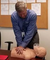 A person practicing cpr on a mannequin

Description automatically generated